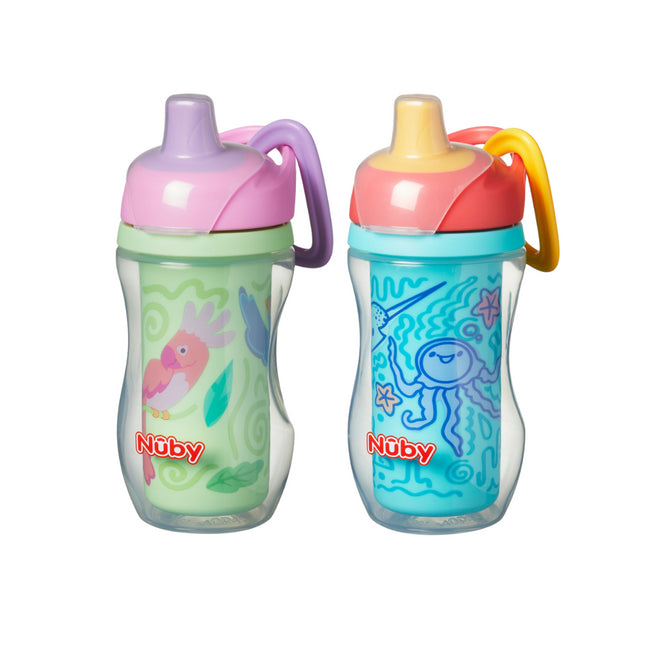 The Nuby UK Insulated Sipper Cup 2 pack includes a green cup with a pink lid and birds, and a blue cup with yellow lid and sea-themed octopus print. Both cups feature handles and a spill-free silicone spout.