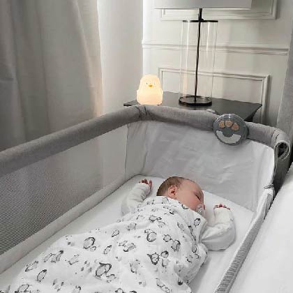 baby sleeping in a crib linking to sleep page to shop