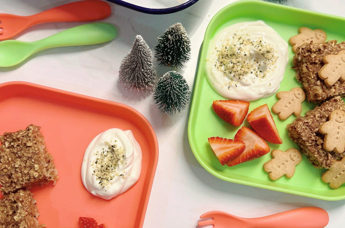 A close up of the baked gingerbread oats that the recipe mentions, laid out on a table top with Nuby tableware accompanying it.