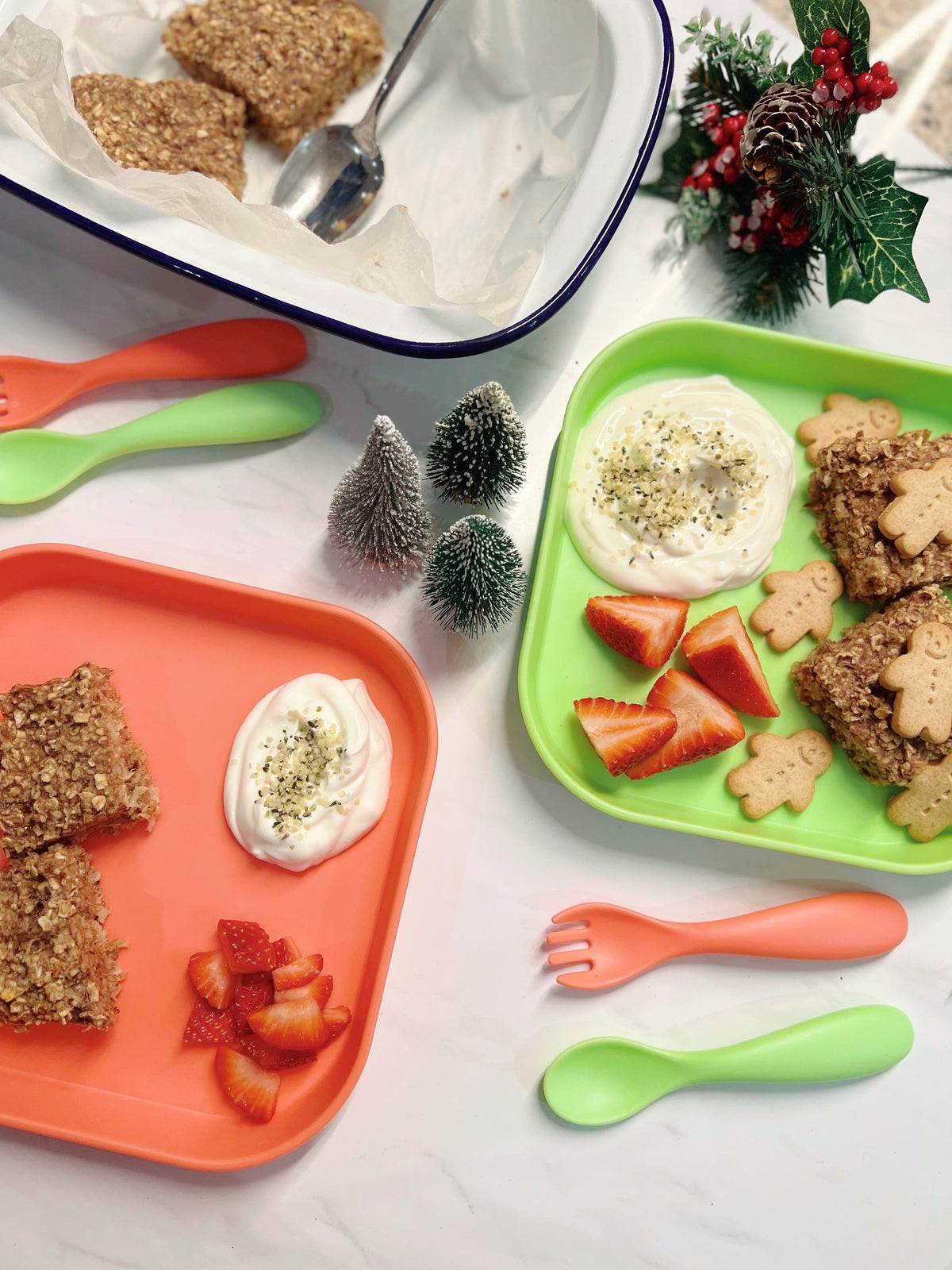 A close up of the baked gingerbread oats that the recipe mentions, laid out on a table top with Nuby tableware accompanying it.
