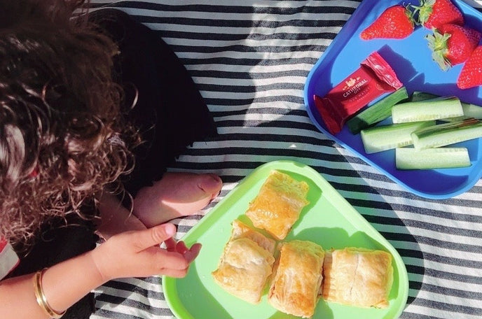 A set of sausage roll slices on top of a Nuby plate