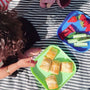 A set of sausage roll slices on top of a Nuby plate
