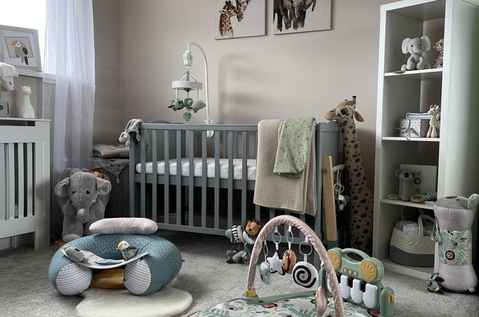A baby's nursery in neutral colours includinng a play gym and sit up seat.