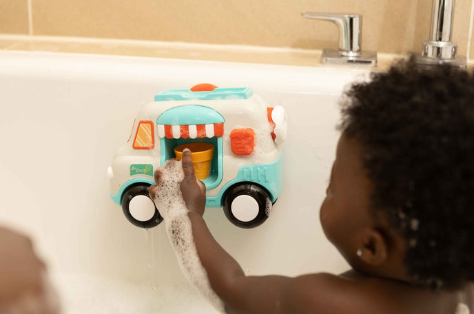 Toddler playing with bath toy
