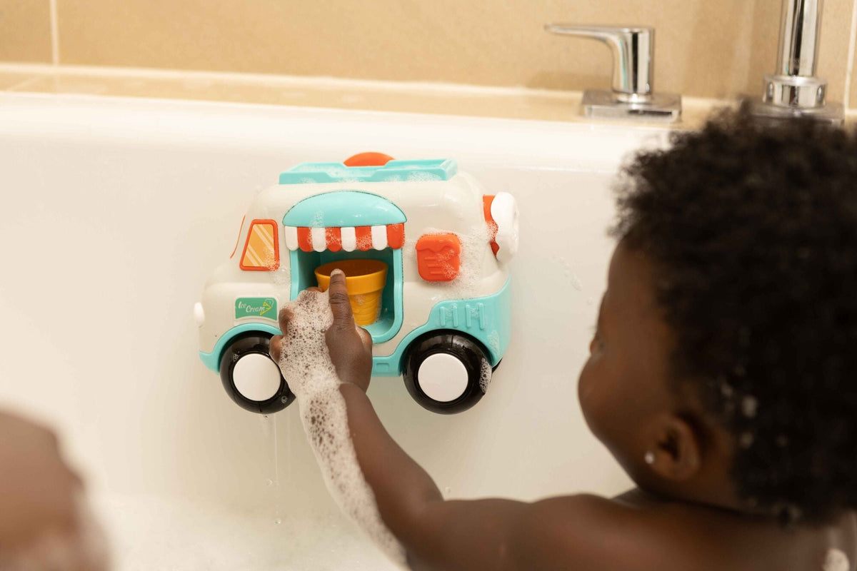 Toddler playing with bath toy