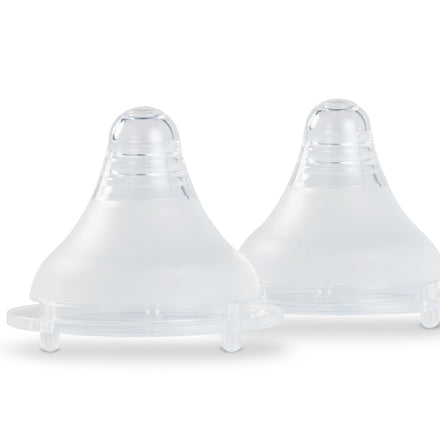 The Nuby UK RapidBottle Teats 2 Pack shows two translucent silicone nipples with a wide base and rounded tip, designed to mimic the feel of a natural breast, side by side on a white background.