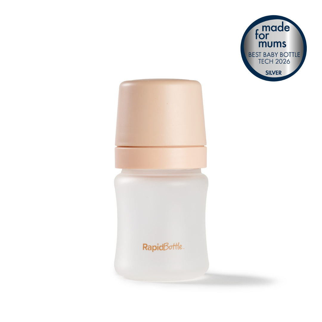 A frosted RapidBottle Anti-Colic Glass Feeding Bottle for newborns with a beige cap. A badge in the top right corner reads: Made for Mums BEST BABY BOTTLE TECH 2026 SILVER.