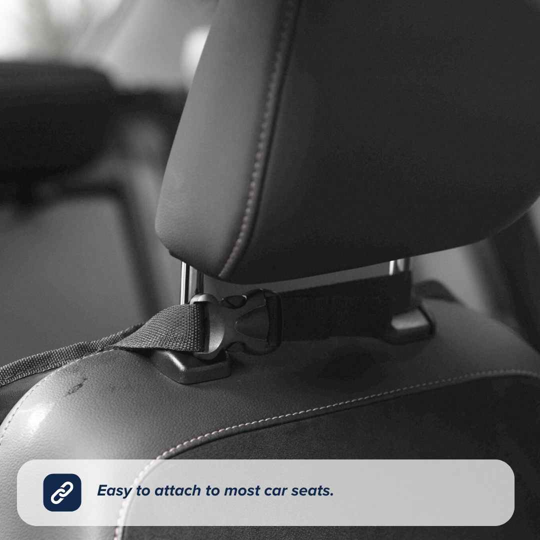 A close-up of a car seat headrest with a strap and buckle fastened around the metal posts. Text overlay: Easy to attach to most car seats—the Nuby Car Seat Organiser is perfect for any backseat storage or travel solution.