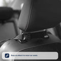 A close-up of a car seat headrest with a strap and buckle fastened around the metal posts. Text overlay: Easy to attach to most car seats—the Nuby Car Seat Organiser is perfect for any backseat storage or travel solution.