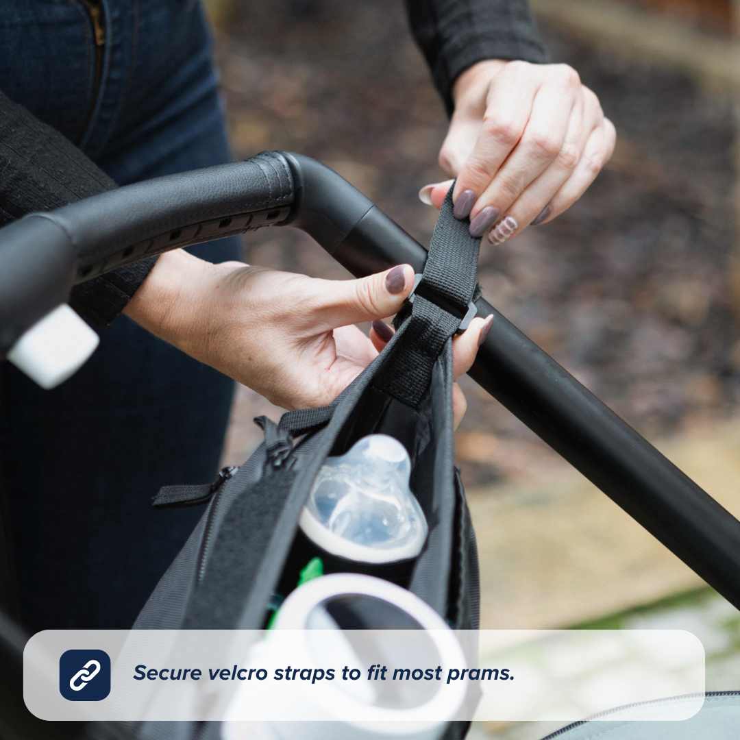 A person attaches the Nuby Pram Organiser Bag with a baby bottle inside to a stroller handle using Velcro straps. Text at the bottom reads, Secure velcro straps to fit most prams.