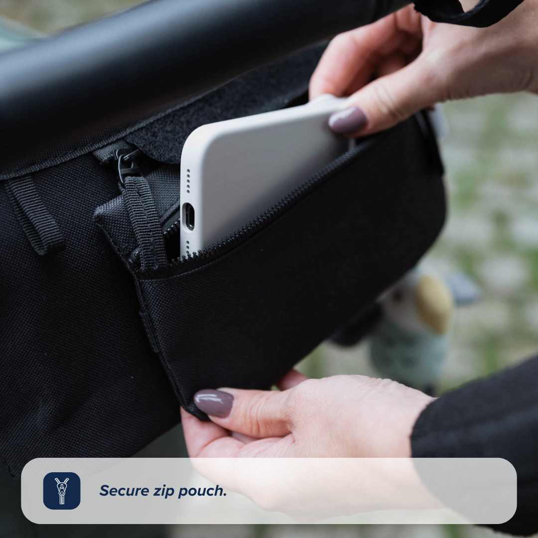 A person places a white smartphone into a black Nuby Pram Organiser Bag zipped to a stroller handlebar. Text reads: Secure pram organiser bag.