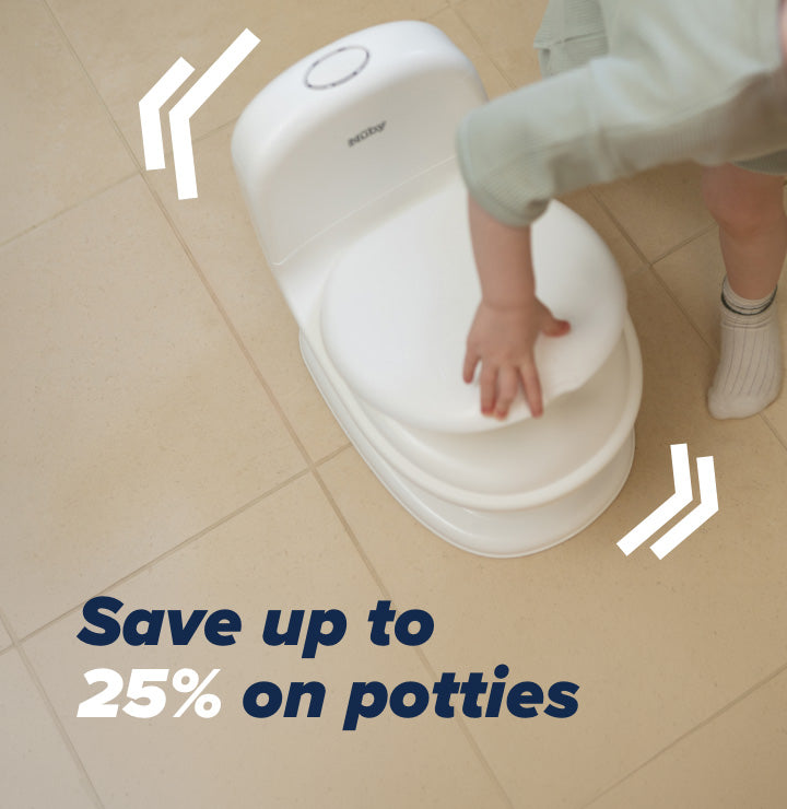 A child opening the lid to their Nuby potty.