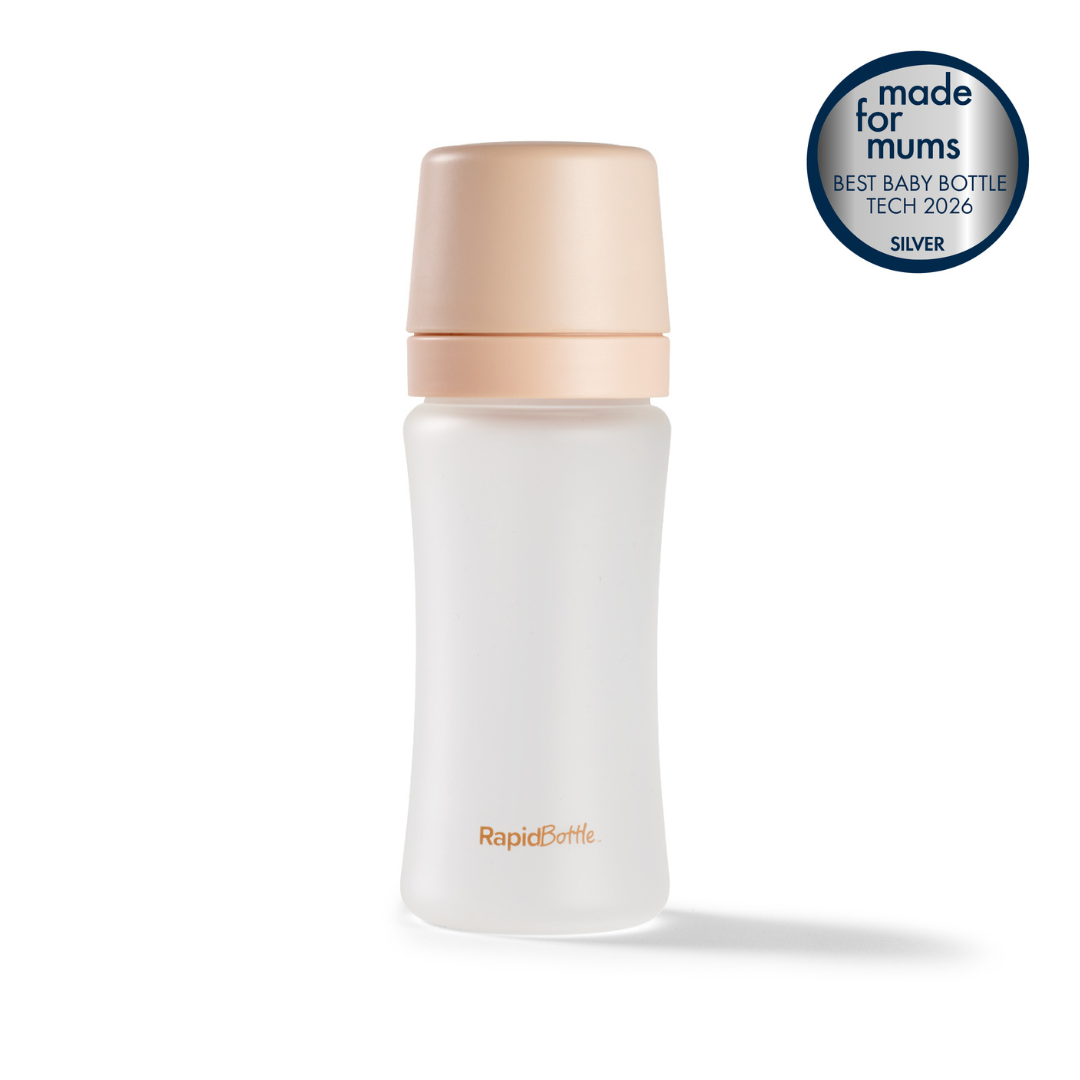 The RapidBottle Anti-Colic Glass Feeding Bottle features frosted glass and a beige cap. A round badge states "made for mums BEST BABY BOTTLE TECH 2026 SILVER"—making it an ideal newborn baby bottle, thoughtfully designed for both safety and convenience.