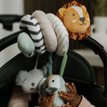 A baby’s hands reach for plush lion, koala, and bird toys on a striped spiral toy from the Nuby UK Animal Adventures Nursery Bundle—ideal for playtime at home or on the go with a Baby Floor Seat or Play Mat with Gym.