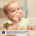 A baby in a light green outfit holds a beige silicone dummy near their mouth. Text reads: The RapidSoother 2-pack of Dummies features a symmetrical shaped teat, allowing your baby to reposition and soothe either way up.