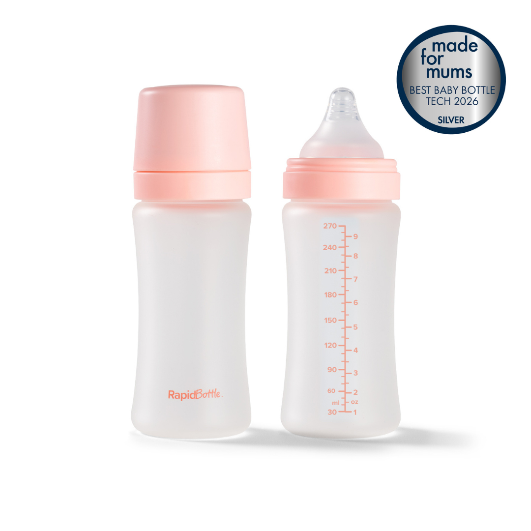 The RapidBottle 2 Pack Glass Baby Bottles, 270ml (9oz), are shown side by side with pink caps—one topped with a nipple and the other with a flat lid. Both translucent bottles are BPA free and feature clear measurement markings, providing reassurance for parents. In the top right corner, a silver "Made for Mums" award badge highlights their quality. These bottles are ideal for use with a UV steriliser to ensure thorough cleanliness and safety.