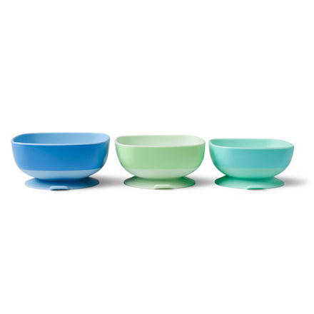 The Baby Suction Bowls Set of 3 features plastic bowls in blue, light green, and teal with rounded shapes and wide bases for baby-led weaning and self-feeding, arranged in a row against a white background.