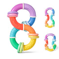 The Twista Rattle Teether is a colorful, figure-eight shaped baby sensory toy with both textured and smooth surfaces, featuring rings in purple, blue, red, orange, yellow, and green to help soothe teething discomfort. Smaller images of the Twista Rattle Teether are displayed on the right.