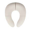 A white, foldable toilet seat shown from above, featuring four sections and a horseshoe shape—this Foldable Toilet Seat provides a convenient and hygienic option for toddler potty training while traveling.