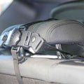 Close-up of a car seat headrest with a black adjustable strap and buckle fastened around it, designed to hold the Safe and Secure Baby Car Mirror, showing fabric details and the locking mechanism for shatter resistance.