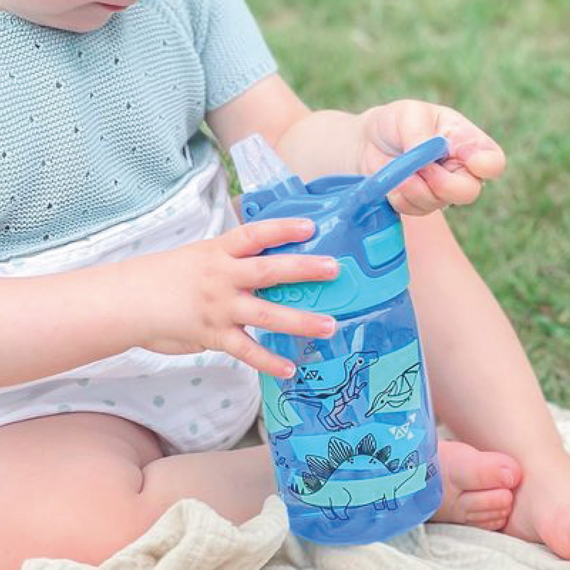 A close up of the Dinosaur decorated Incredible Gulp water bottle from Nuby.