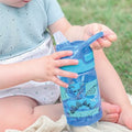 A close up of the Dinosaur decorated Incredible Gulp water bottle from Nuby.
