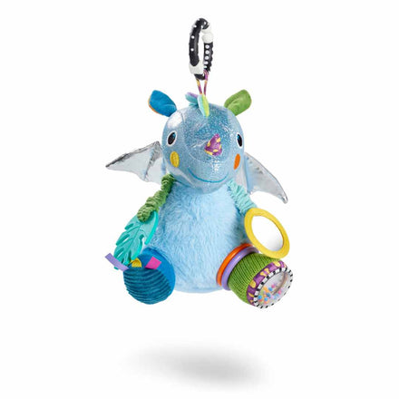 The Things with Wings George Pram Toy is a colorful sensory plush unicorn with shiny blue fabric, wings, and multicolored rings. It features a black and white clip for hanging, shown on a white background.