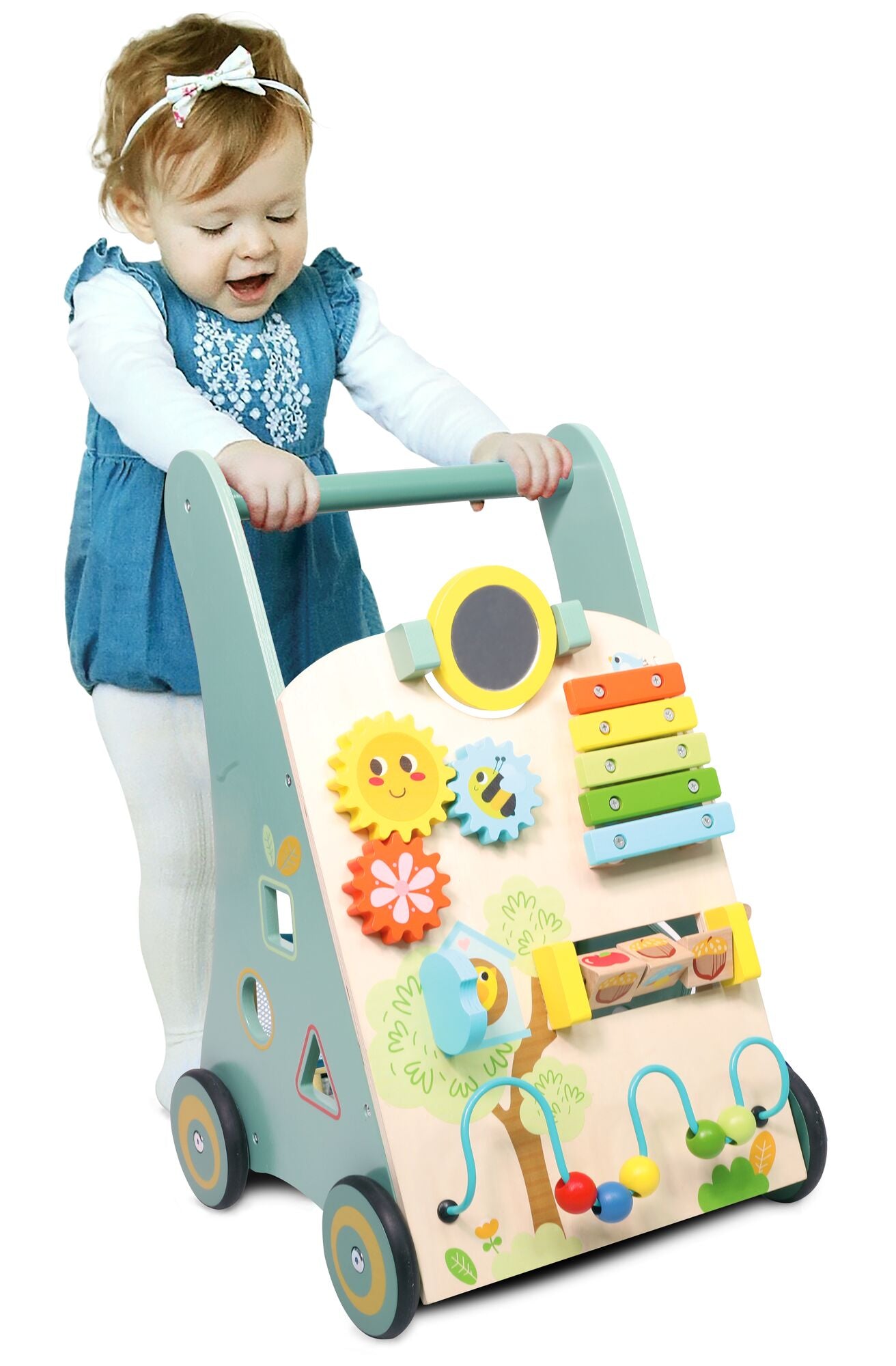 A smiling toddler in a blue dress plays with the Nuby Wooden Baby Walker, a colorful activity walker featuring gears, a xylophone, mirror, beads, and charming animal designs—a delightful walking aid for babies.