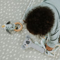 A baby interacting with their Animal Adventures toys from Nuby.