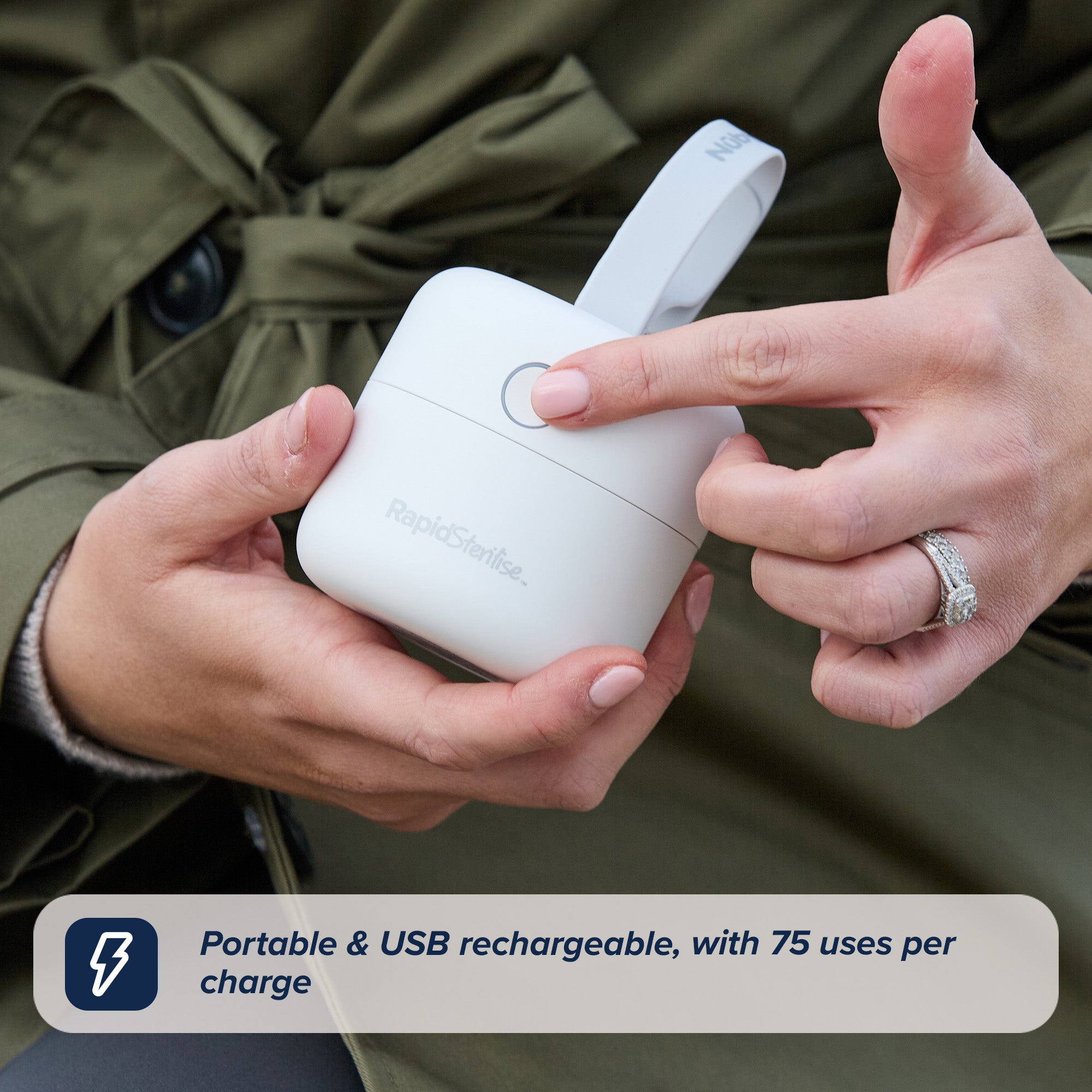 A hand presses the button on a white RapidSterilise UV Soother Steriliser with strap. Text: Portable, USB rechargeable, rapid sterilising; delivers up to 75 uses per charge.