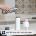 An insulator flask pouring hot water into a RapidCool. This is in a kitchen setting while being surrounded by Nuby products on the kitchen worktop including the RapidBottle fitted with the RapidSterilise+.