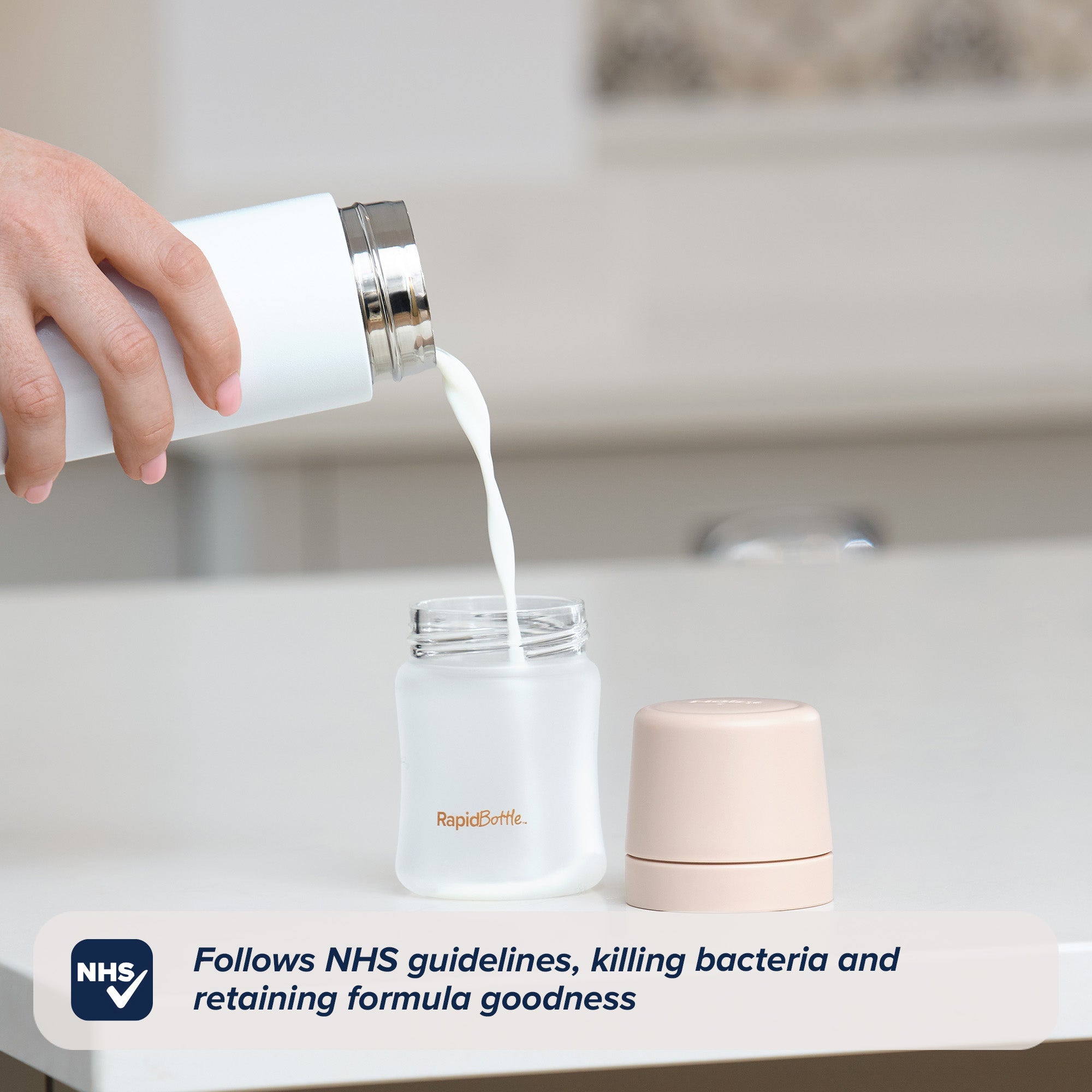 Formula being poured from a RapidCool into a RapidBottle that is sat on a white kitchen worktop.