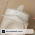 A My Real Mini Toilet Potty features a built-in full-size white wipes dispenser on top, with a tissue sticking out.