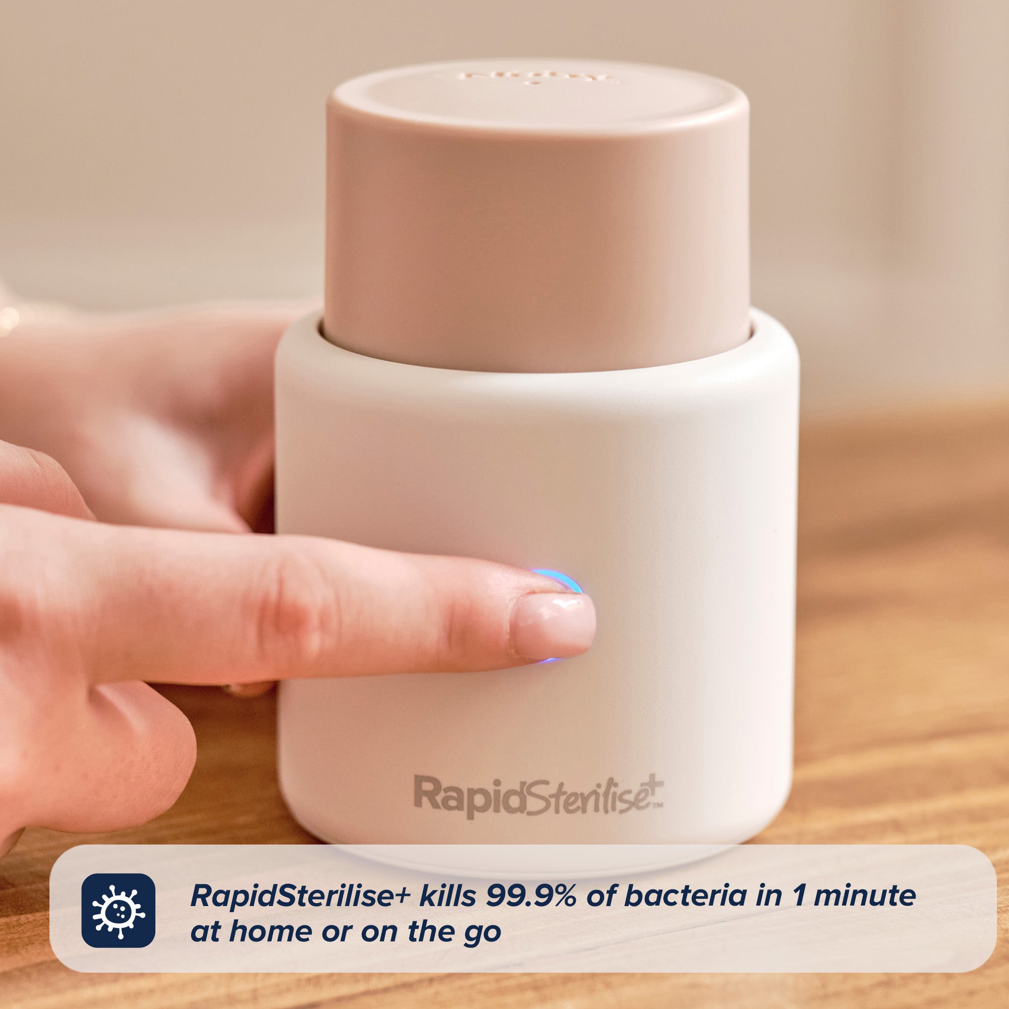 A hand touches the top of a small, white, cylindrical RapidSoother Dummy & Pod. Text reads: RapidSoother Dummy & Pod kills 99.9% of bacteria in 1 minute at home or on the go.