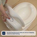 A child presses a button on the My Real Mini Toilet Potty, featuring a lifelike flushing handle. Text overlay: “Life like flushing sound adds fun and an engaging reward to toilet training.”.