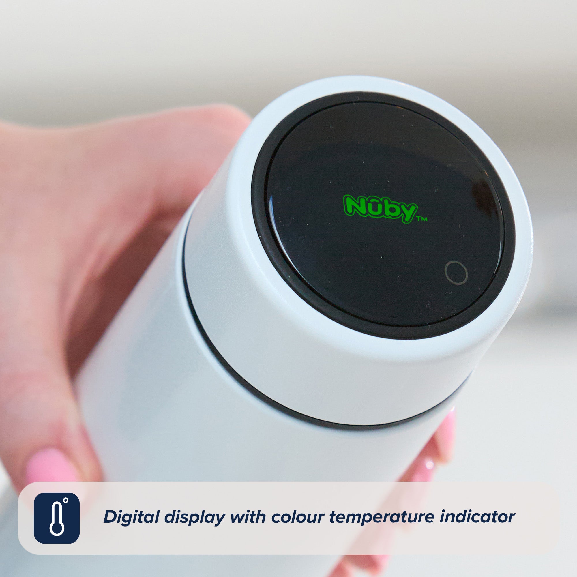 A close up photograph of a woman holding the Nuby RapidCool to camera with the green Nuby logo showing on the top of the flask style gadget.