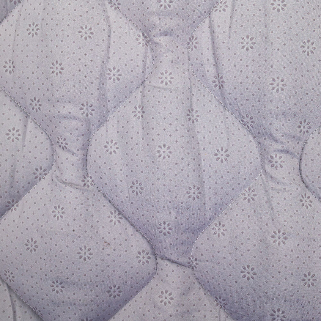 Close-up of the Quilted Playmat's light purple, diamond-stitched surface with small floral and dotted patterns—providing a soft, anti-slip area ideal for safe baby playtime.