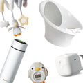 Blundell Bundel - Hannah’s Newborn Must-Haves by Nuby UK includes essentials like a plush penguin mobile, white baby bathtub, RapidCool thermos, penguin-shaped bath thermometer, and a white baby wipe dispenser.