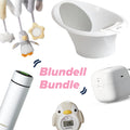 A collage of newborn essentials features Nuby UK’s Blundell Bundel - Hannah’s Newborn Must-Haves: a white baby bath, plush penguin mobile, white bottle warmer, RapidCool insulated bottle, penguin thermometer, and pink “Blundell Bundel” text.