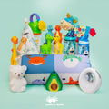 A Nuby Mystery Box featuring colorful children's toys, water bottles, baby essentials, and bedtime items is arranged on a mint green background with the Cash for Kids logo at the bottom center.