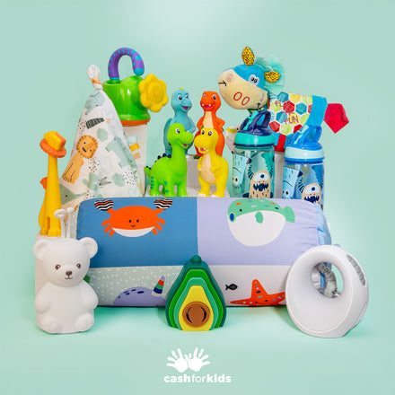A Nuby Mystery Box featuring colorful children's toys, water bottles, baby essentials, and bedtime items is arranged on a mint green background with the Cash for Kids logo at the bottom center.