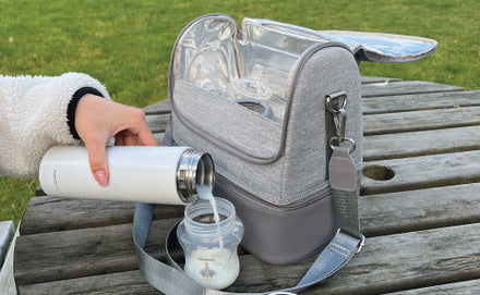 A photo of the RapidCool pouring feed into a sterilised cup next to the Portable UV Steriliser on a bench in the park.