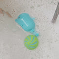 Dolphin and bath toys sat in a bath by Nuby.