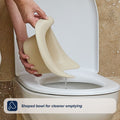 A hand pours liquid from a flexible, beige bowl into a toilet. Text at the bottom reads, Shaped bowl for cleaner emptying—perfect for potty training with the Easy Clean Potty Beige’s removable insert.