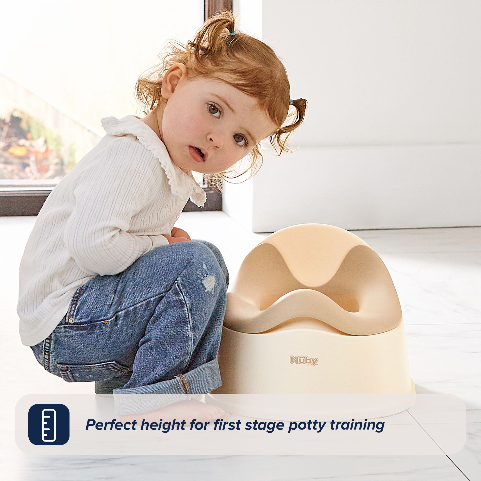 A young child in a white shirt and jeans kneels beside the Easy Clean Potty Beige, looking at the camera. Text reads: Perfect height for first stage potty training, featuring a removable insert for easy cleaning.