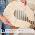 A person holds a Foldable Toilet Seat with non-slip suction cups above a white toilet. Text overlay: Non-slip suction cups help keep things steady.