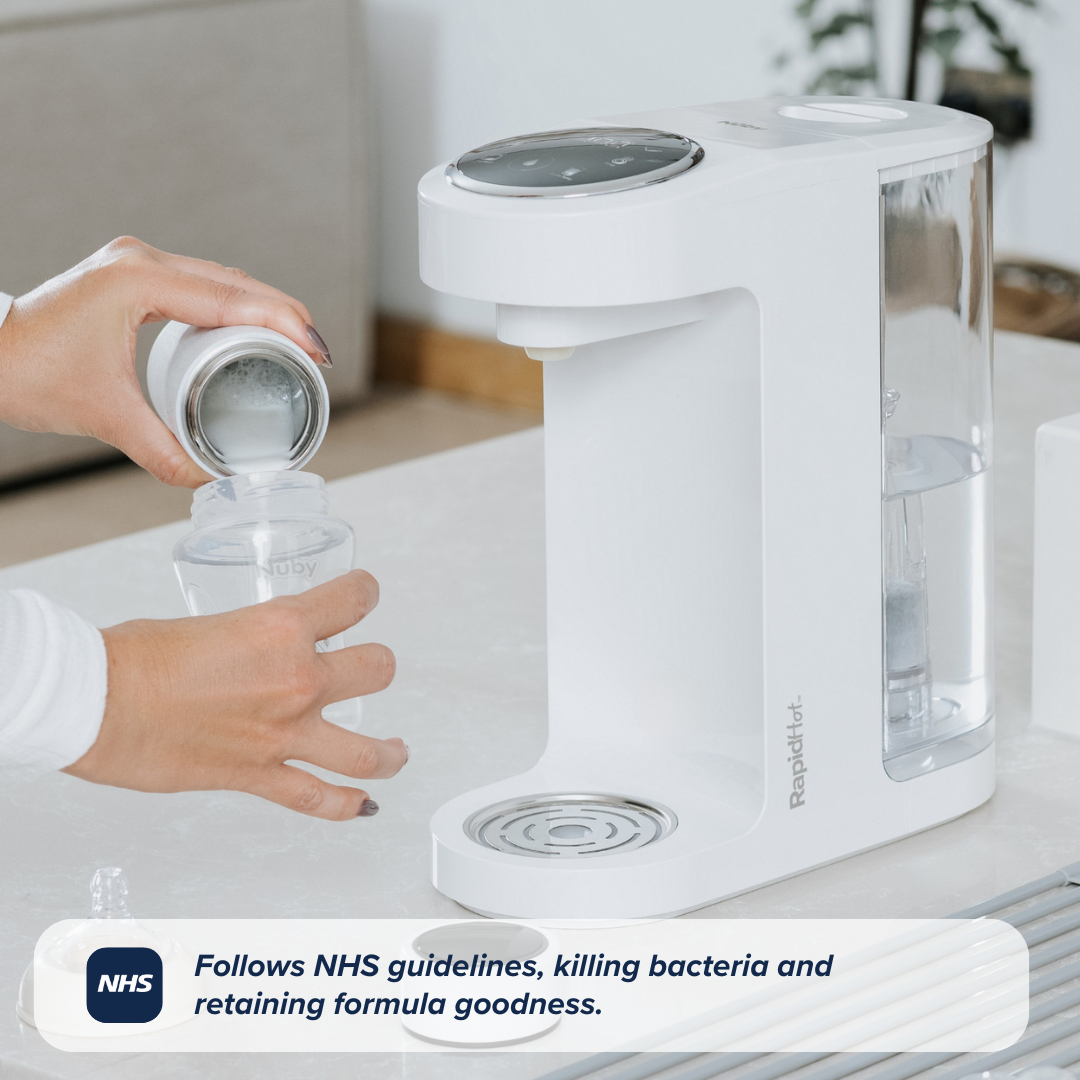 A bottle with feed being poured into it alongside a RapidHot device. This is on a kitchen counter top.