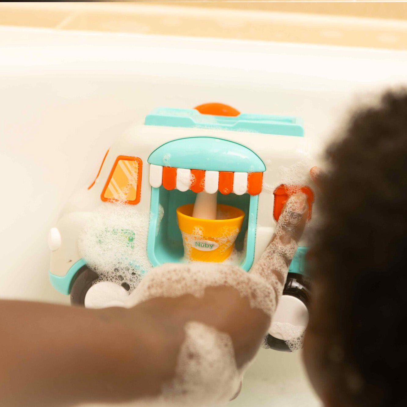 Ice cream bath toy by Nuby. The button bringing out foam to replicate an ice cream van.