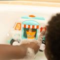 Ice cream bath toy by Nuby. The button bringing out foam to replicate an ice cream van.