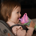 A young child holding the Insulated Sipper cup by Nuby.